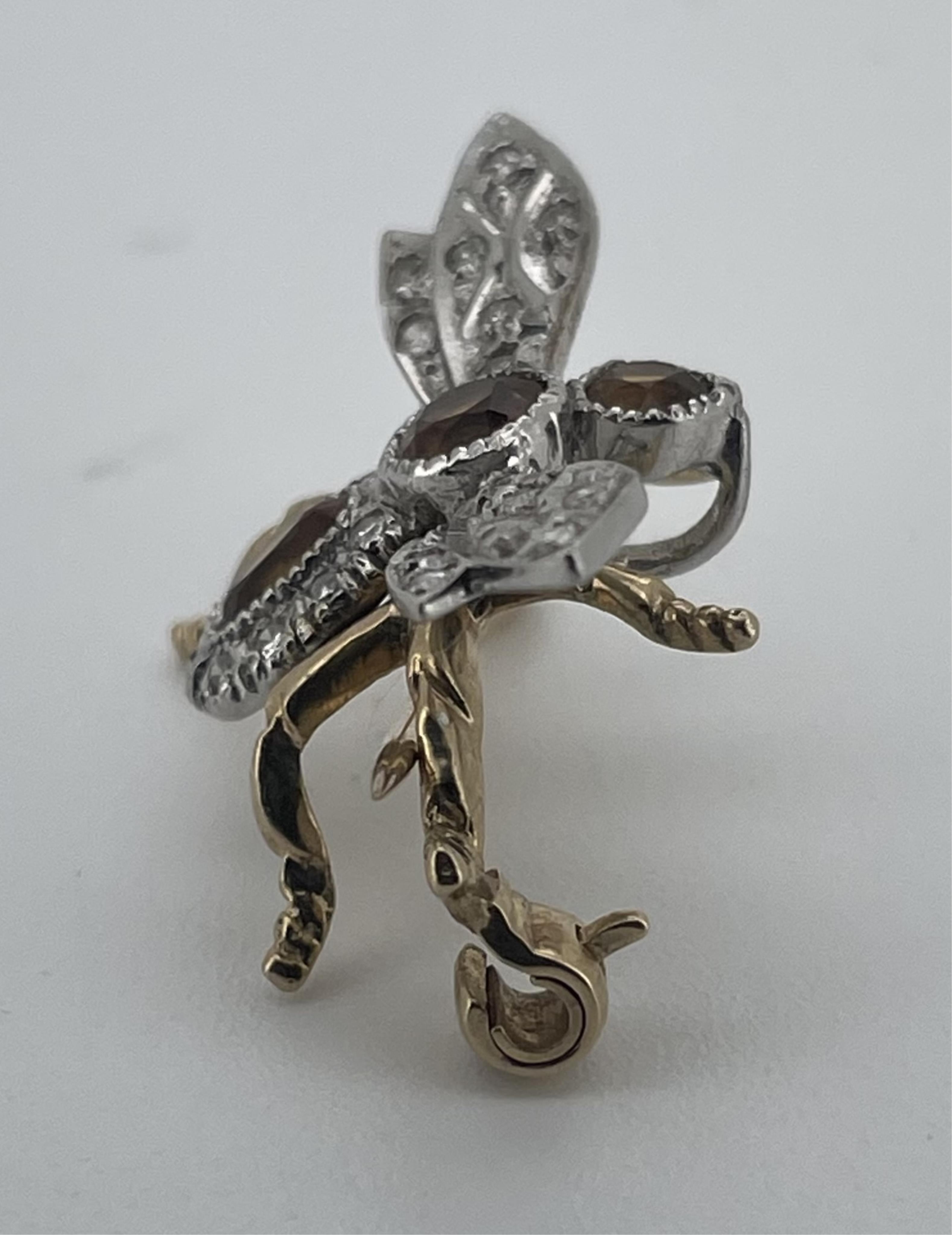 A citrine and diamond brooch, circa 1987, designed as a bee, set with circular-cut and oval yellow citrines and brilliant-cut diamonds, mounted in bicoloured 9ct gold, wingspan approximately 2.4cm, British hallmarks for